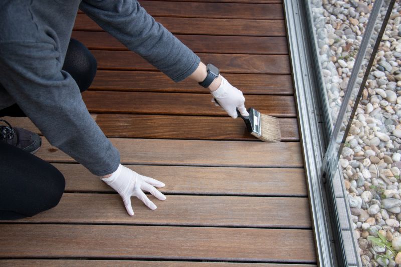 Applying stain on a deck